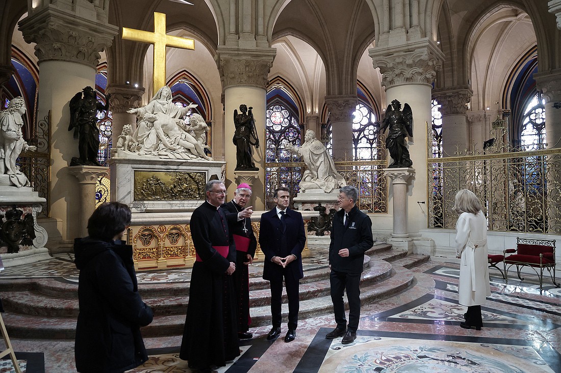 French President Emmanuel Macron, center, is seen during a visit to Notre Dame Cathedral in Paris Nov. 29, 2024. The cathedral is set to reopen in early December, with a planned weekend of ceremonies on Dec. 7 and 8, five years after the 2019 fire that ravaged the world heritage landmark and toppled its spire. Some 250 companies and hundreds of experts were mobilized for the five-year restoration costing hundreds of millions of euros. (OSV News photo/Christophe Petit Tesson, pool via Reuters)