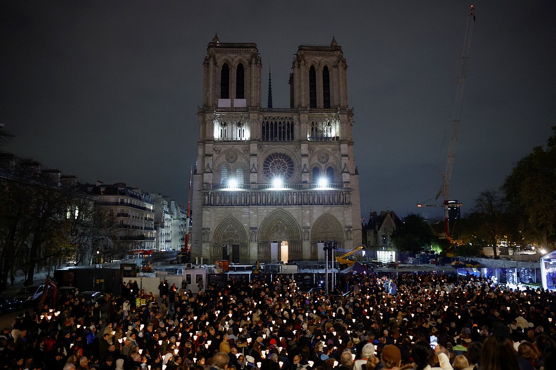 People attend a Marian candlelit procession Nov. 15, 2024, where the Virgin of Paris statue returns to Notre Dame Cathedral in Paris, after it was kept at the Saint-Germain-l'Auxerrois Church near the Louvre for five years since Notre Dame was ravaged by a fire in 2019. (OSV News photo/Stephanie Lecocq, Reuters)