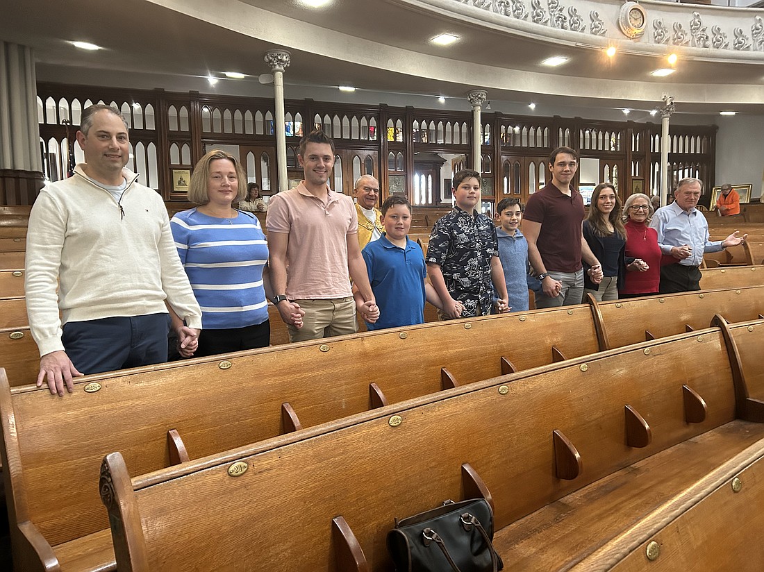 The Smith family consists of parents, Ryan and Suzanne (from l.), along with their children, Timothy, 24, Charlie, 9, Henry, 13, James, 11, Sam, 18 and Grace, 23. As well as Suzanne’s parents, Eileen and Robert Wood. Behind the family is Father Richard Carlino, pastor at St. John the Evangelist and St. Anthony’s parishes in Schenectady. (Mike Matvey photo)