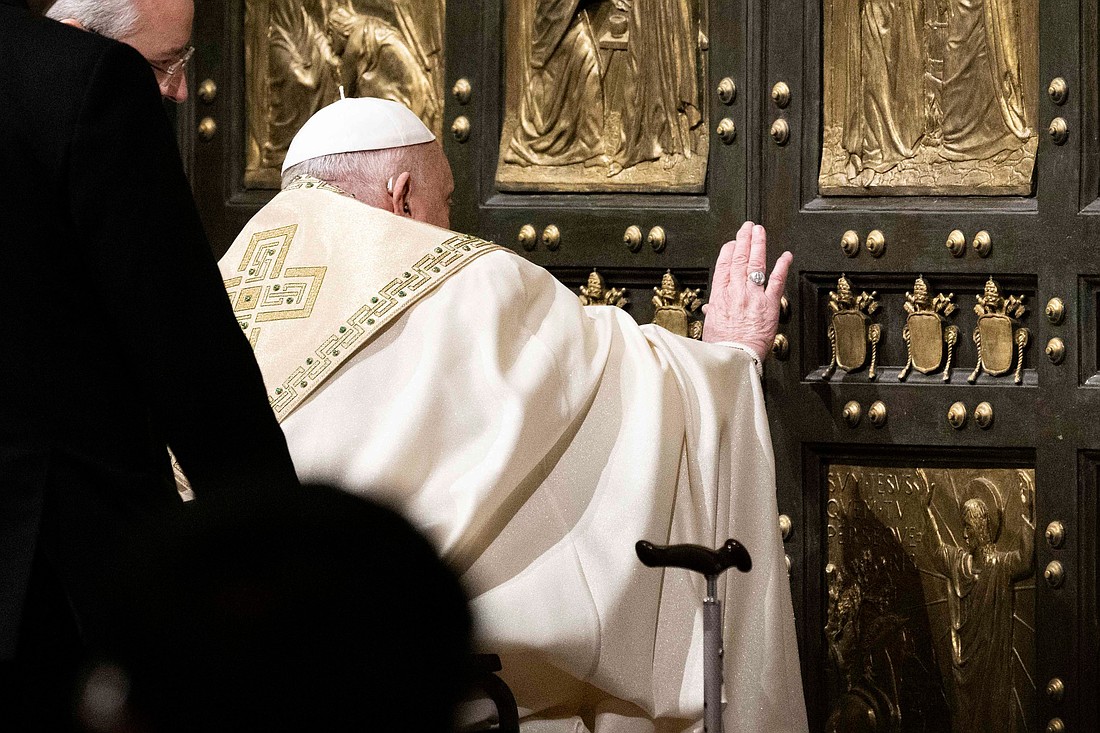 Pope Francis pushes open the Holy Door of St. Peter's Basilica at the Vatican Dec. 24, 2024, inaugurating the Holy Year 2025. (CNS photo/Cristian Gennari, pool)