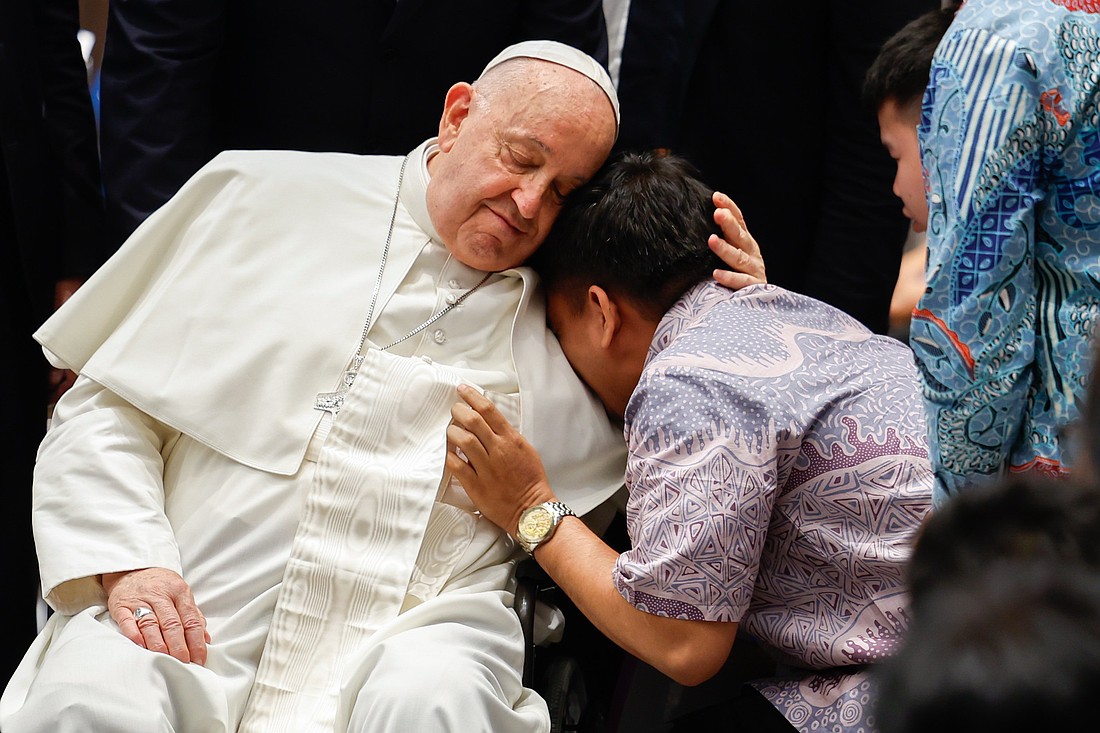 Pope Francis offers comfort to an individual during a meeting with a group of the sick, people with disabilities, and the poor, supported by various charitable organizations, at the Indonesian bishops’ conference headquarters in Jakarta, Indonesia, on Sept. 5, 2024. (CNS photo/Lola Gomez)