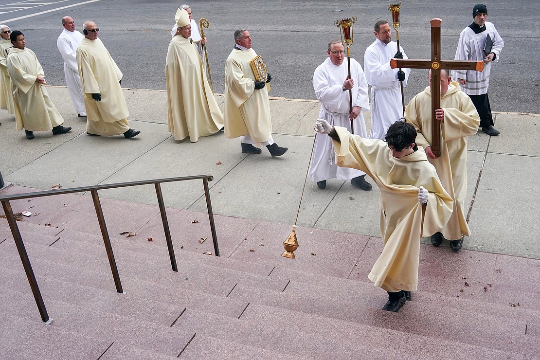 The Jubilee 2025 Pilgrimage arrives at the Cathedral of the Immaculate Conception on Jan. 5 on Eagle Street in Albany. Bishop Edward B. Scharfenberger, clergy and parishioners process behind a cross as they take part in the pilgrimage from Historic St. Mary’s to the Cathedral in Albany for the opening of Jubilee Year 2025. Cindy Schultz photo for The Evangelist)