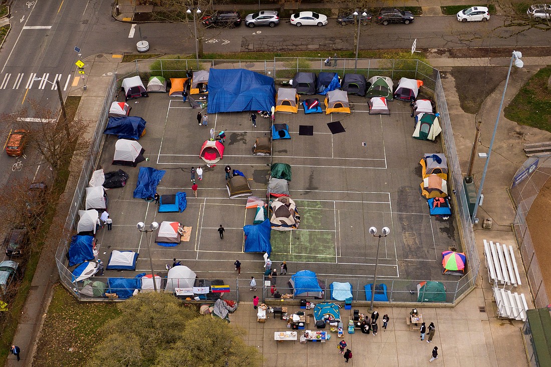 A group of mostly Venezuelan migrants camp on the tennis courts of a community center after losing access to other shelter in Seattle April 3, 2024. The Trump administration cancelled travel plans for refugees previously approved under the resettlement program. (OSV News photo/David Ryder, Reuters)