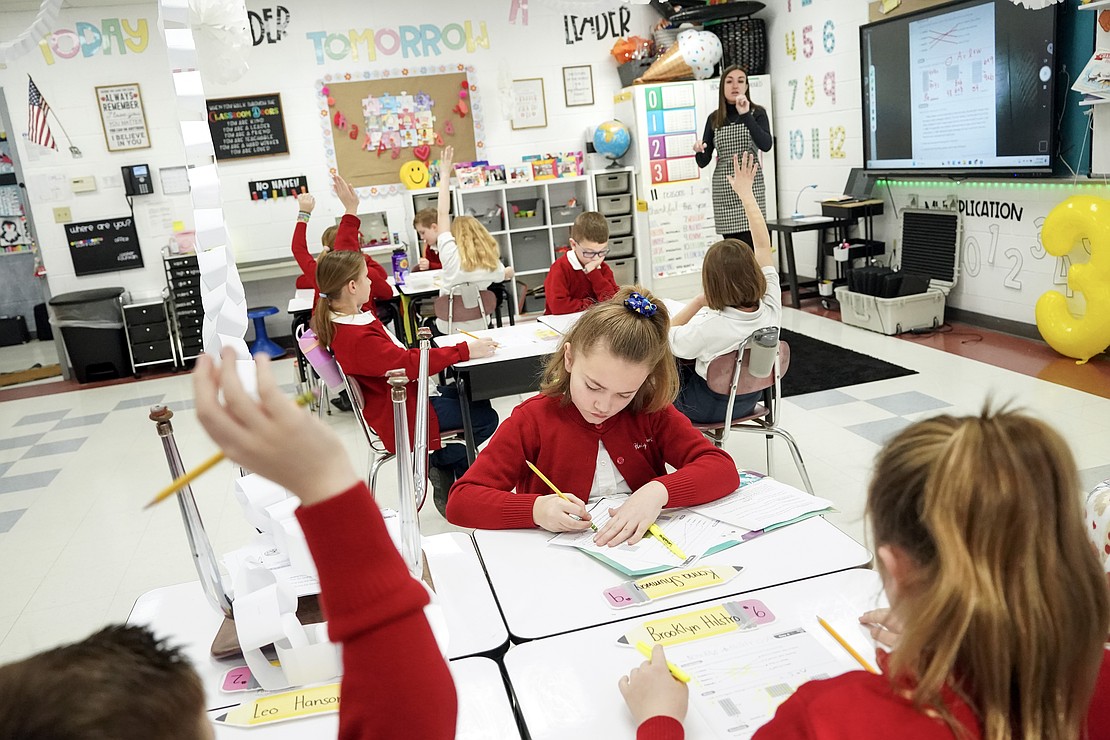 Kenna Shumway, center, makes a correction as third-grade teacher Gabrielle Pike leads the class on Jan. 16 at Holy Spirit School in East Greenbush. (Cindy Schultz photo for The Evangelist)