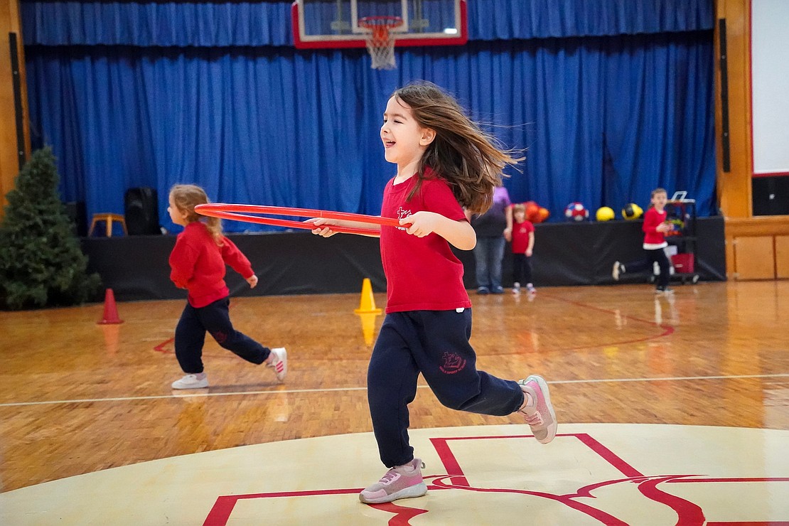 Kindergartner Kinsley Bonesteel plays a game of tag during gym class on Jan. 16 at Holy Spirit School in East Greenbush. (Cindy Schultz photo for The Evangelist)