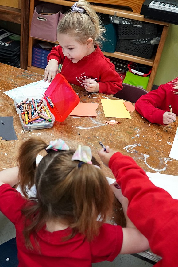 Jerrie Rosenstock, 4, and her Pre-K class make artwort using torn paper and glue  on Jan. 16 at Holy Spirit School in East Greenbush. (Cindy Schultz photo for The Evangelist)