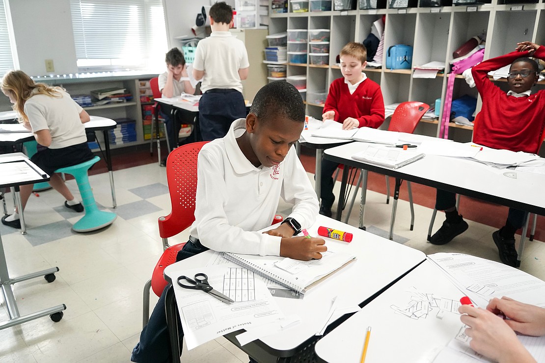 Fifth grader Godson Omoniyi studies science and states of matter on Jan. 16 at Holy Spirit School in East Greenbush. (Cindy Schultz photo for The Evangelist)