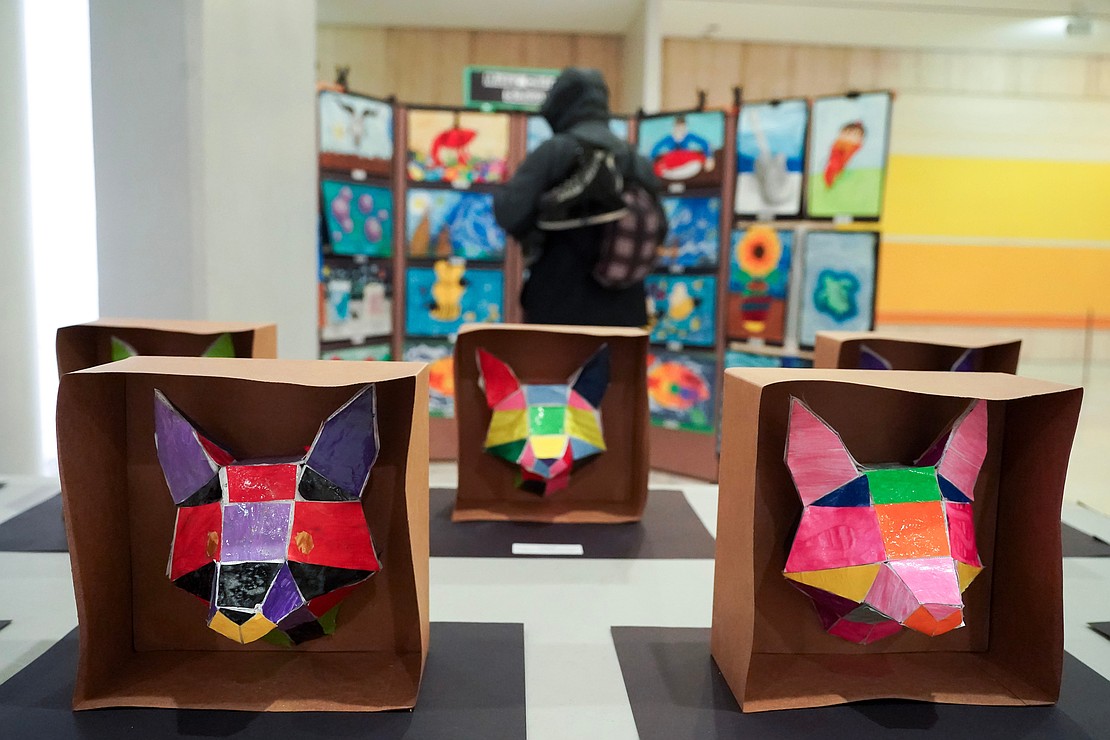 Mater Christi School eight-graders artwork, in the foreground, is part of the Catholic Schools Week Art Exhibit at the Empire State Plaza South Concourse in Albany. (Cindy Schultz photo for The Evangelist)