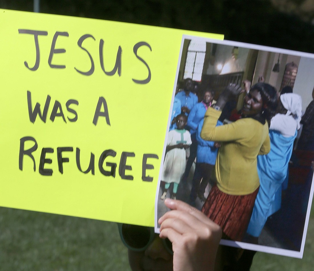 A protester holds up a sign during an Oct. 15, 2019, demonstration outside the U.S. Capitol in Washington against the first Trump administration's cuts in the number of refugees to be admitted under the U.S. resettlement program. The U.S. bishops Feb. 18, 2025, sued the second Trump administration for its abrupt halt to funds for resettling refugees. (OSV News photo/Bob Roller, CNS file)