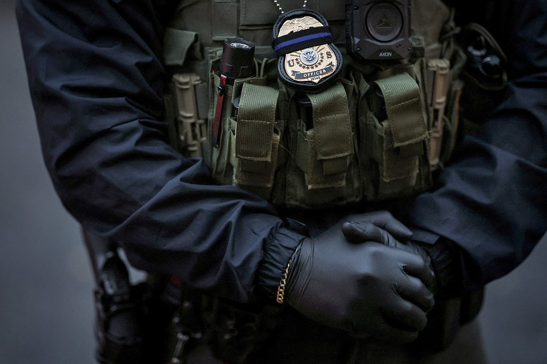 An officer from U.S. Immigration and Customs Enforcement stands next to his vehicle in Laurel, Md., Feb. 6, 2025. A federal judge in Maryland has issued a temporary order preventing immigration enforcement operations at 1,700 places of worship in 35 states, but stopped short of a nationwide injunction. (OSV News photo/Leah Millis, Reuters)