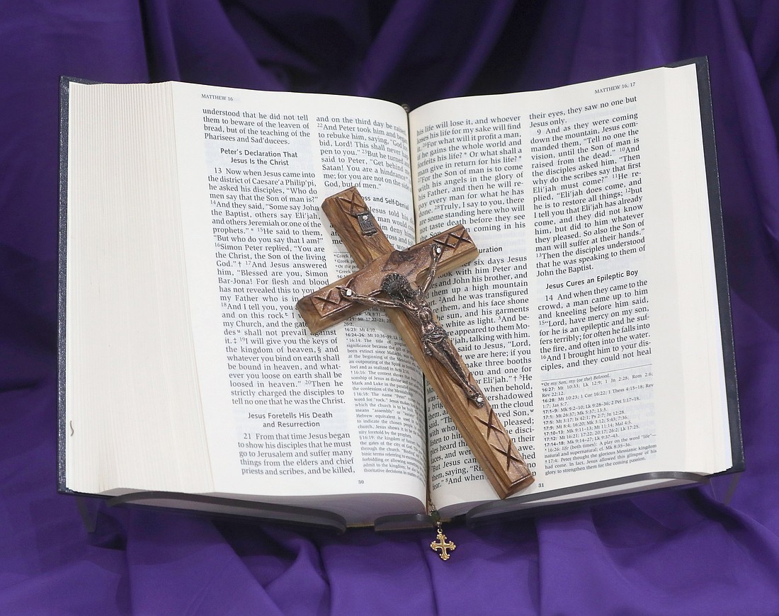 A crucifix and Bible are pictured on purple cloth during Lent at Jesus the Good Shepherd Church in Dunkirk, Md. (OSV News photo/Bob Roller, Reuters)