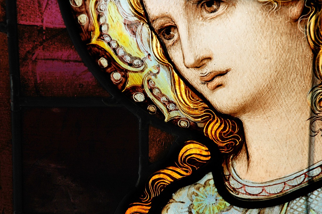 Close-up of  a stained glass window depicting Mary.