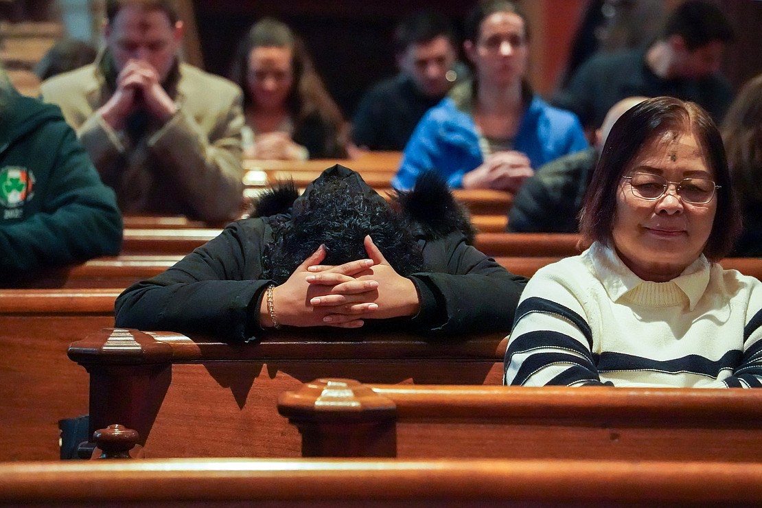 Parishioners pray after receiving ashes during Ash Wednesday Mass on March 5 at the Cathedral of the Immaculate Conception in Albany. (Cindy Schultz photo for The Evangelist)