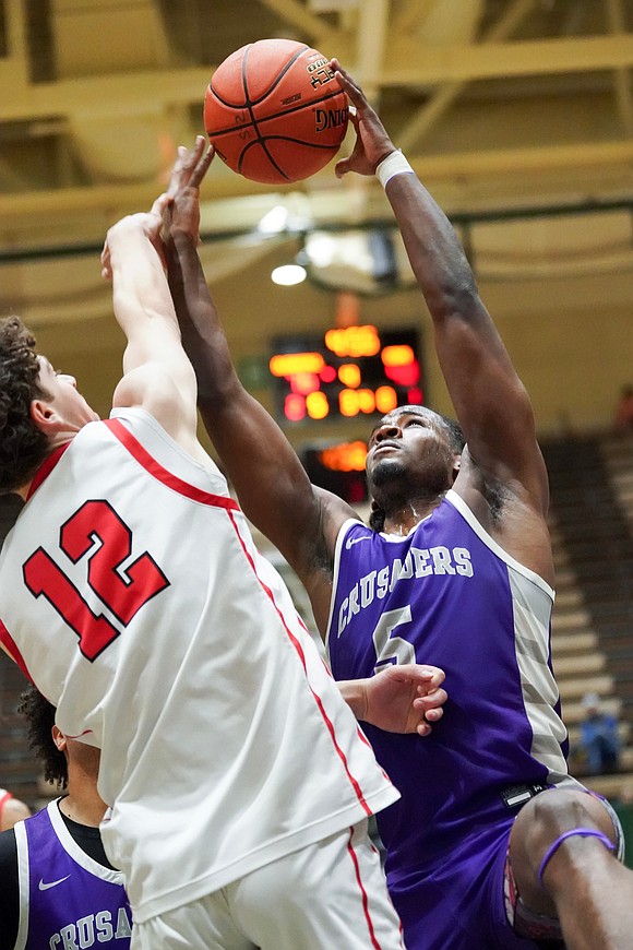 Catholic Central’s Qwameik Smith goes to the hoop as Glens Falls’ Bryce McClenning defends during the Crusaders' Section II Class A final basketball game against Glens Falls on March 8 at Hudson Valley Community College in Troy. Glens Falls won 93-59. (Cindy Schultz photo for The Evangelist)