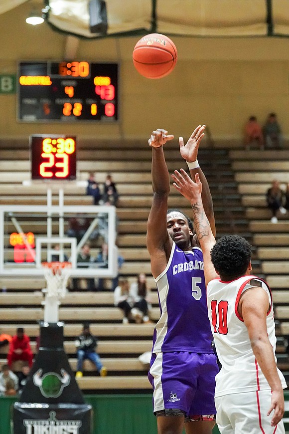 Catholic Central’s Qwameik Smith goes to the hoop as Glens Falls’ Ralphael Maldonado defends during the Crusaders' Section II Class A final basketball game against Glens Falls on March 8 at Hudson Valley Community College in Troy. Glens Falls won 93-59. (Cindy Schultz photo for The Evangelist)