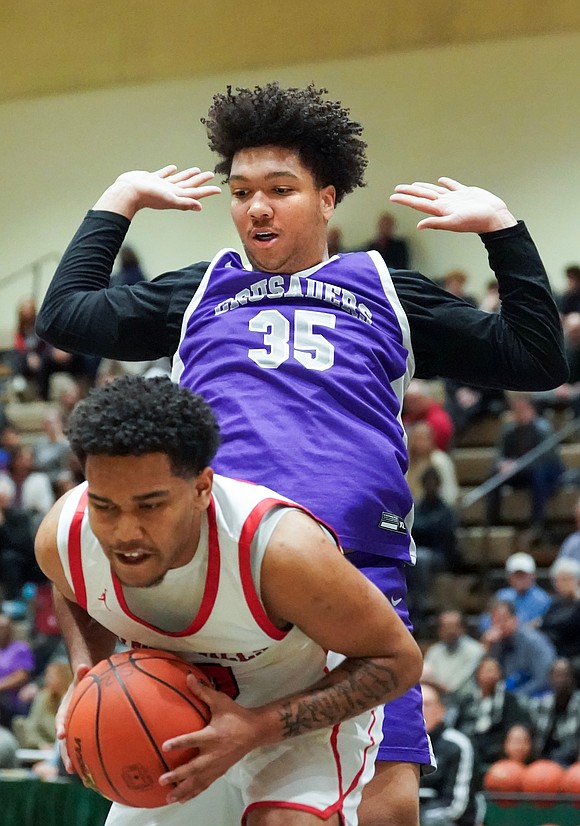 Catholic Central’s Adrtian Mallory  defends Glens Falls’ Ralphael Maldonado during the Crusaders' Section II Class A final basketball game against Glens Falls on March 8, at Hudson Valley Community College in Troy. Glens Falls won 93-59. (Cindy Schultz photo for The Evangelist)