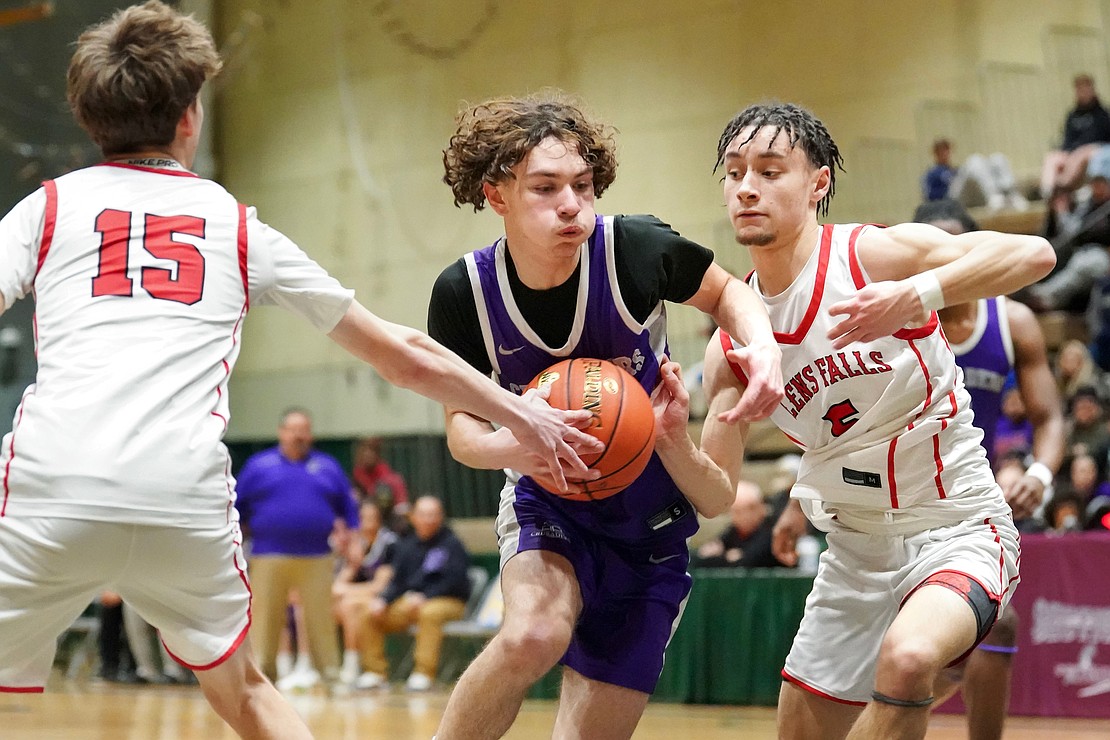 Catholic Central’s John Sapienza  controls the ball as Glens Falls’ Luke MacDougall (l.) and Oscar Lilac defend during the Crusaders' Section II Class A final basketball game against Glens Falls on March 8, at Hudson Valley Community College in Troy. Glens Falls won 93-59. (Cindy Schultz photo for The Evangelist)