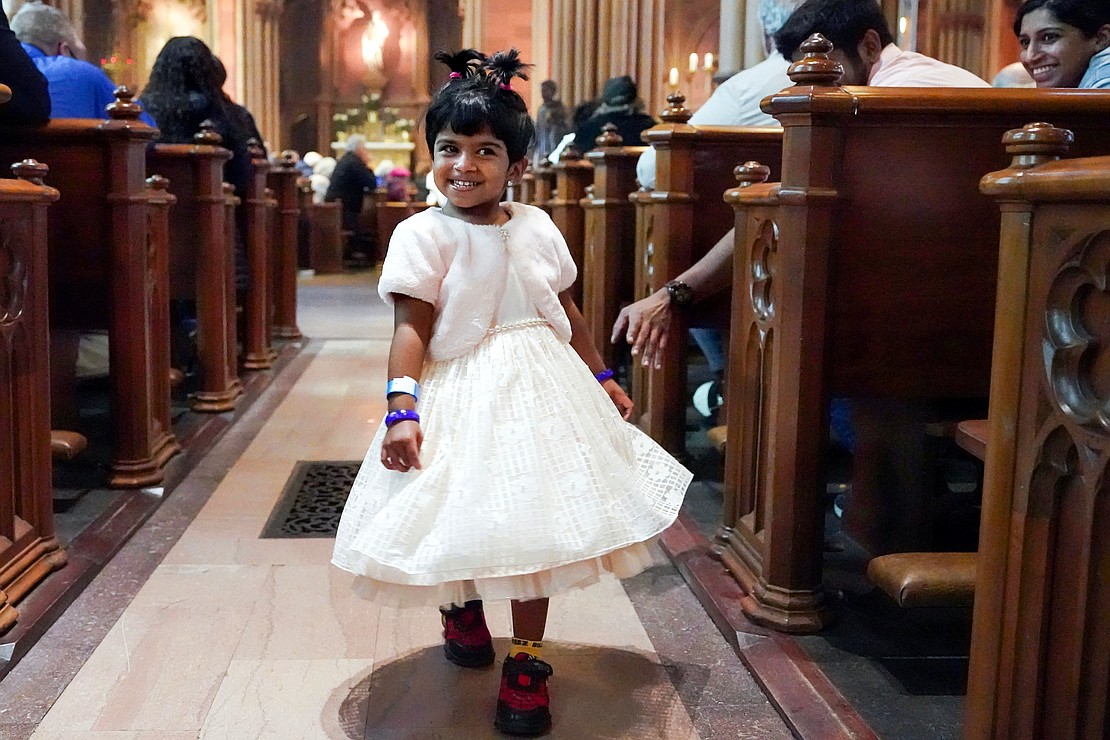 Essa-Marie Luke, 3, shows off her Easter dress during Easter Mass on April 20 at the Cathedral of the Immaculate Conception in Albany. (Cindy Schultz photo for The Evangelist)