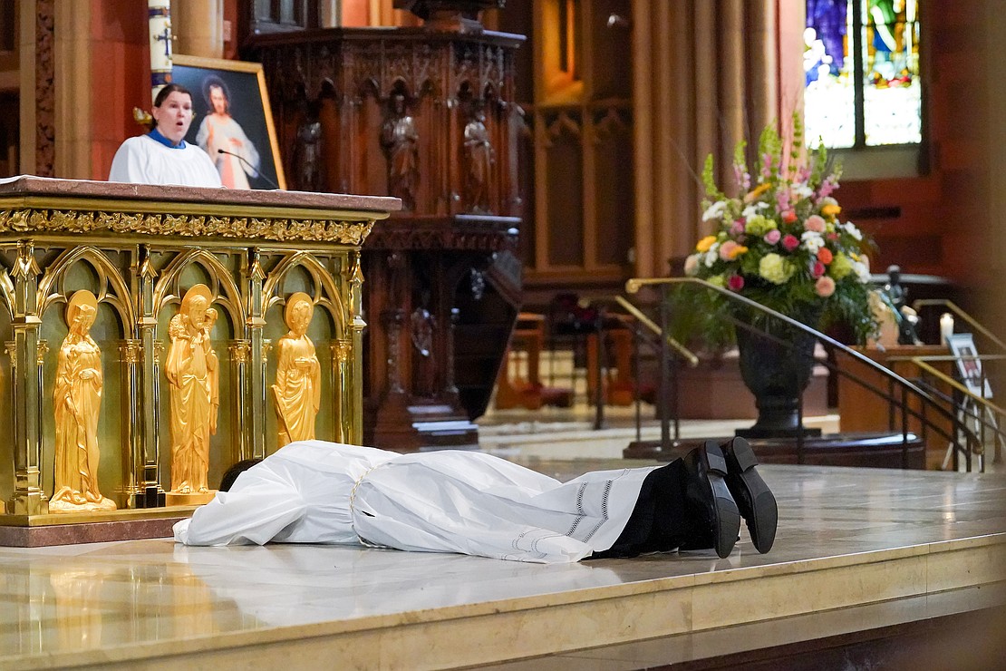 Alexander Turpin, candidate for deacon, lays in supplication during his Ordination to the Diaconate on May 17 at the Cathedral of the Immaculate Conception in Albany. (Cindy Schultz for The Evangelist)