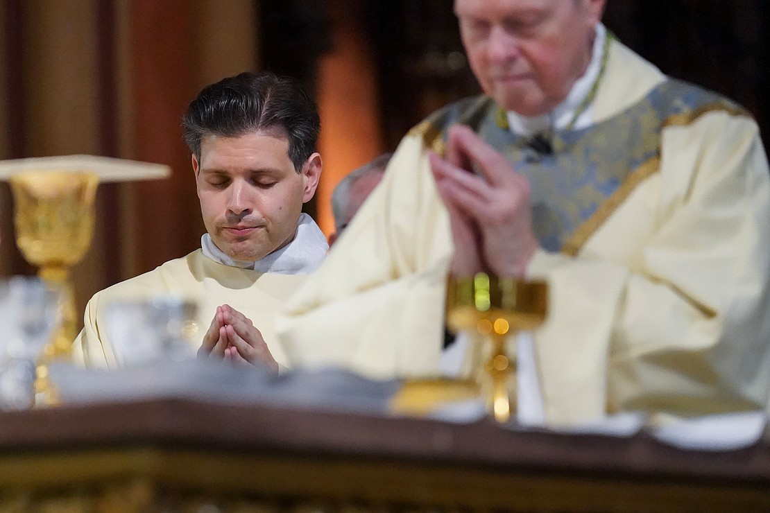 Newly ordained deacon Alexander Turpin prays with Bishop Edward B. Scharfenberger during the Liturgy of the Eucharist following his Ordination to the Diaconate on May 17 at the Cathedral of the Immaculate Conception in Albany. (Cindy Schultz for The Evangelist)