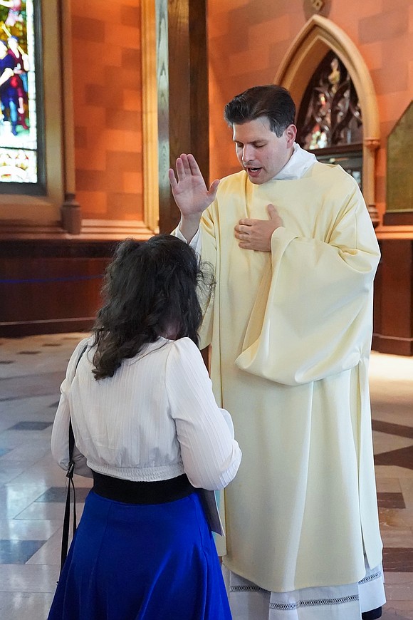 Newly ordained deacon Alexander Turpin blesses a parishioner following his Ordination to the Diaconate on May 17 at the Cathedral of the Immaculate Conception in Albany. (Cindy Schultz for The Evangelist)