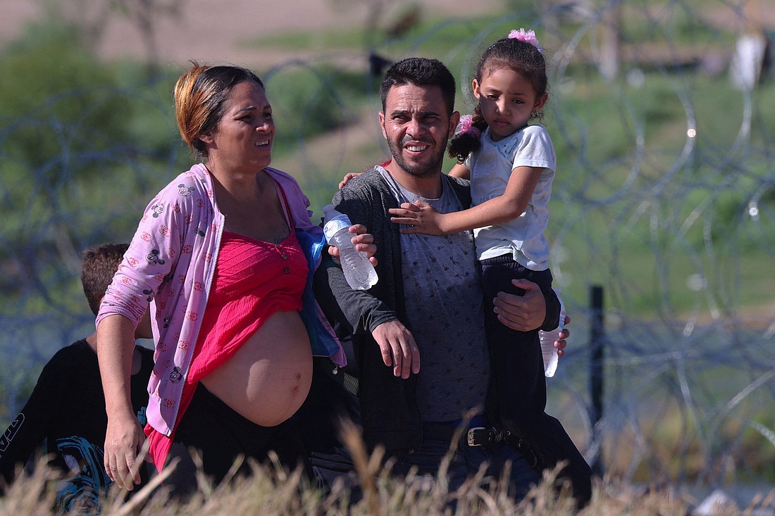 A Cuban migrant family, including a woman who is pregnant, walk to turn themselves in to the U.S. Border Patrol in Eagle Pass, Texas, Sept. 29, 2023. The U.S. Catholic bishops offered both praise and criticism of federal actions affecting human life, such involving gender transition, abortion funding, and pregnant migrants, in a pair of statements March 19, 2025. (OSV News photo/Brian Snyder, Reuters)
