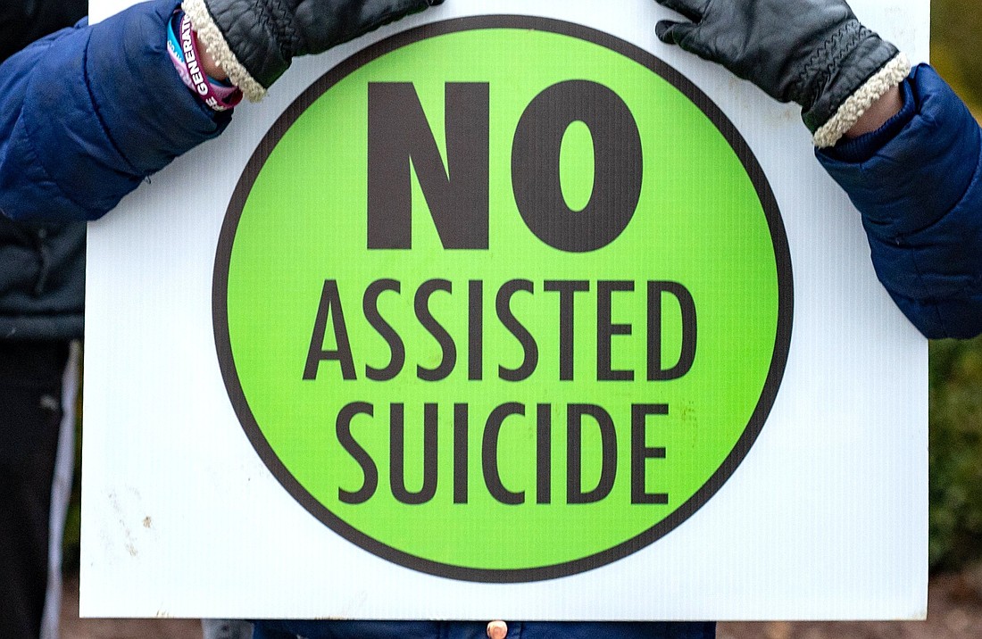 A person is pictured in a file photo holding a sign against physician-assisted suicide. On May 20, 2025, Delaware became the most recent U.S. state to enact assisted suicide legislation when Democratic Gov. Matt Meyer signed into law a measure  allowing adult residents of the state deemed terminally ill to request and self-administer medication to end their lives. (OSV News photo/Kevin J. Parks, Catholic Review)