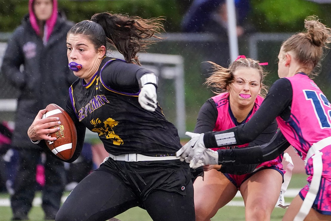 Holy Trinity’s quarterback Kristen Foglia runs a quarterback keeper as Broadalbin-Perth’s Jillie Parkes defends during the Section II Class C flag football final on May 22 at Troy High School in Troy. Holy Trinity won, 19-0. (Cindy Schultz photo for The Evangelist)