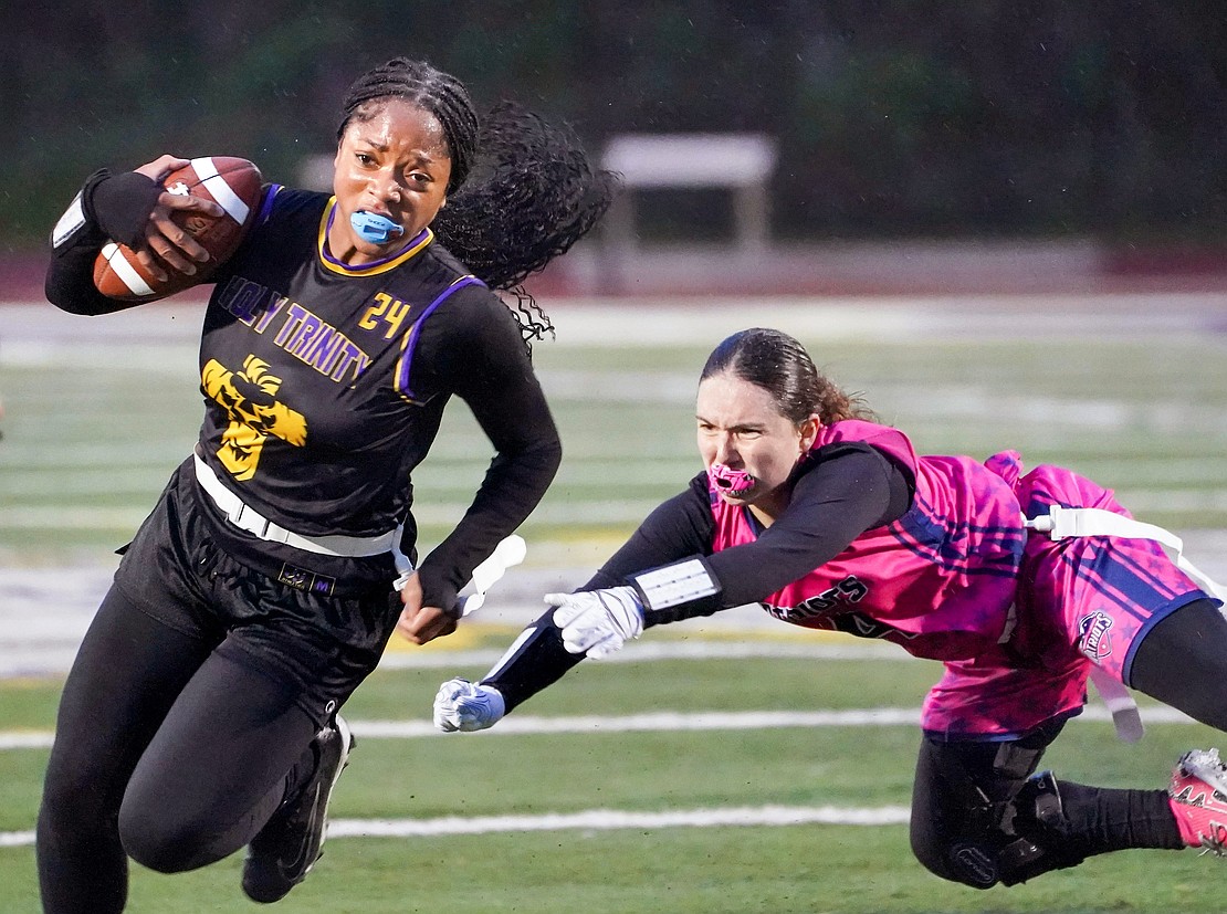 Holy Trinity’s Kelise Campbell (l.) dodges Broadalbin-Perth’s Emily Sliss and runs for a touchdown. (Cindy Schultz photo for The Evangelist)