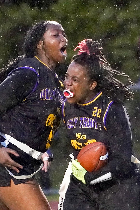 Holy Trinity’s Brooklyn Moore (r.) celebrates a touchdown with Karri Gaddy during the Section II Class C flag football championship on May 22 at Troy High School in Troy. The Pride beat Broadalbin-Perth, 19-0. (Cindy Schultz photo for The Evangelist)