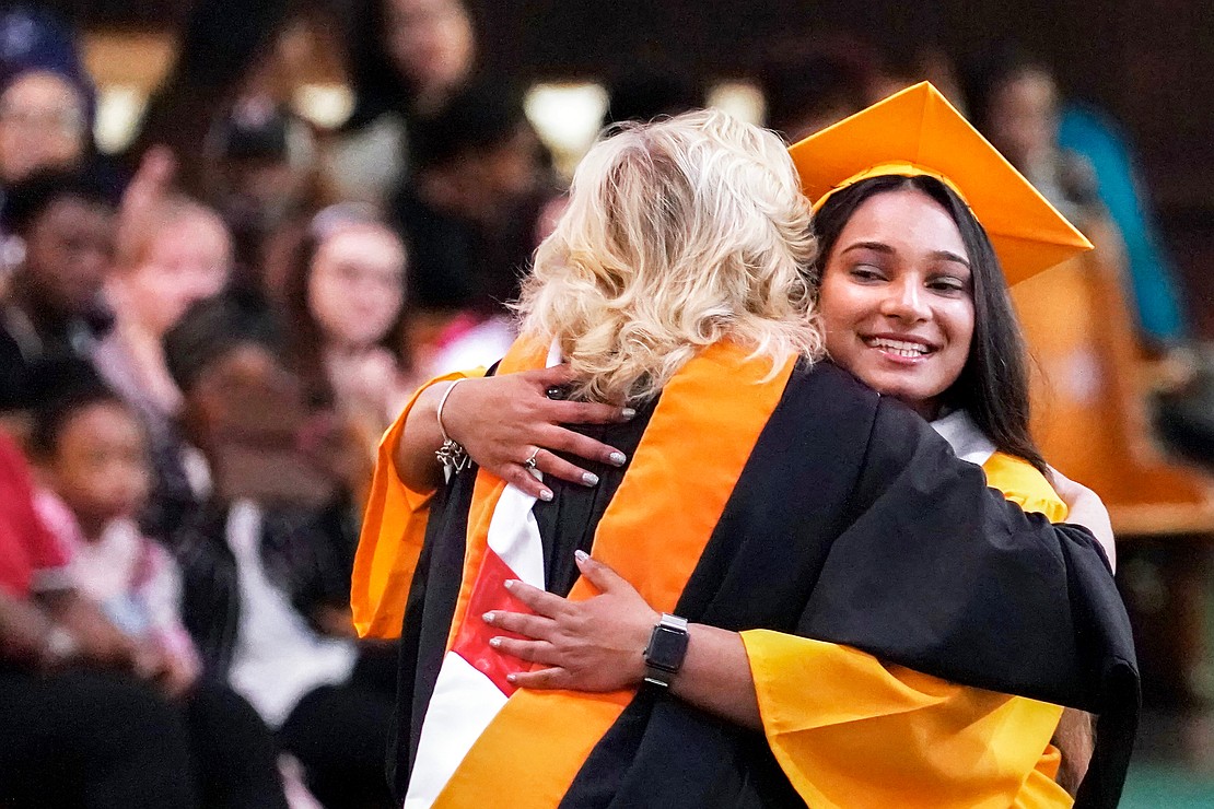 Salutatorian Angelika Cecil receives a hug after delivering ther address to fellow graduates during Notre Dame–Bishop Gibbons' Commencement Exercises on June 7 at St. John the Evangelist in Schenectady. (Cindy Schultz photo for The Evangelist)