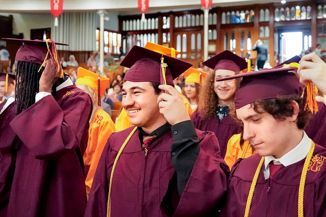 Graduate Kyle Coloumbe (c.)turns the tassel with the Class of 2025 during Notre Dame–Bishop Gibbons' Commencement Exercises on June 7 at St. John the Evangelist in Schenectady. (Cindy Schultz photo for The Evangelist)