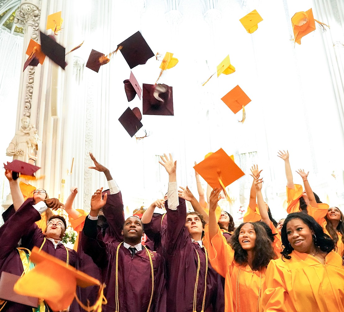 Graduates toss their caps following Notre Dame–Bishop Gibbons' Commencement Exercises on June 7 at St. John the Evangelist in Schenectady. (Cindy Schultz photo for The Evangelist)