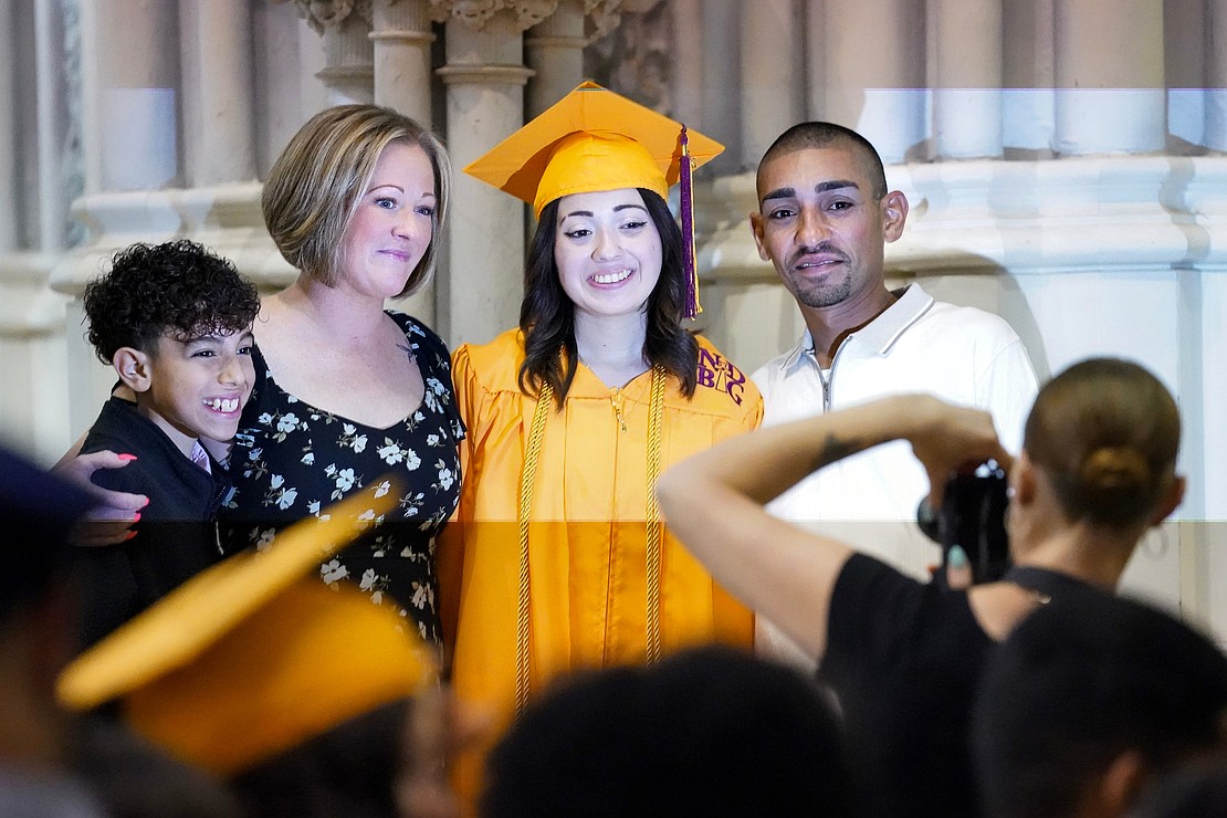 Graduate Alannah Lanzo poses for a picture with her family following Notre Dame– Bishop Gibbons' Commencement Exercises on June 7 at St. John the Evangelist in Schenectady. Joining her (from l.) are Alannah’s brother Jace Lanzo, 11, mother Elaine Willette and father Jaime Lanzo. (Cindy Schultz photo for The Evangelist)