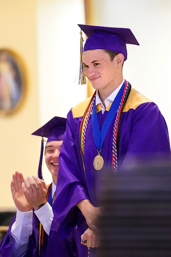 Valedictorian Raphael Sanok, right, stands for recognition as salutatorian David Mattes applauds during Saratoga Catholic Central’s commencement exercises on Friday June 27, 2024, at St. Clement’s Church in Saratoga Springs, N.Y.  Cindy Schultz for The Evangelist