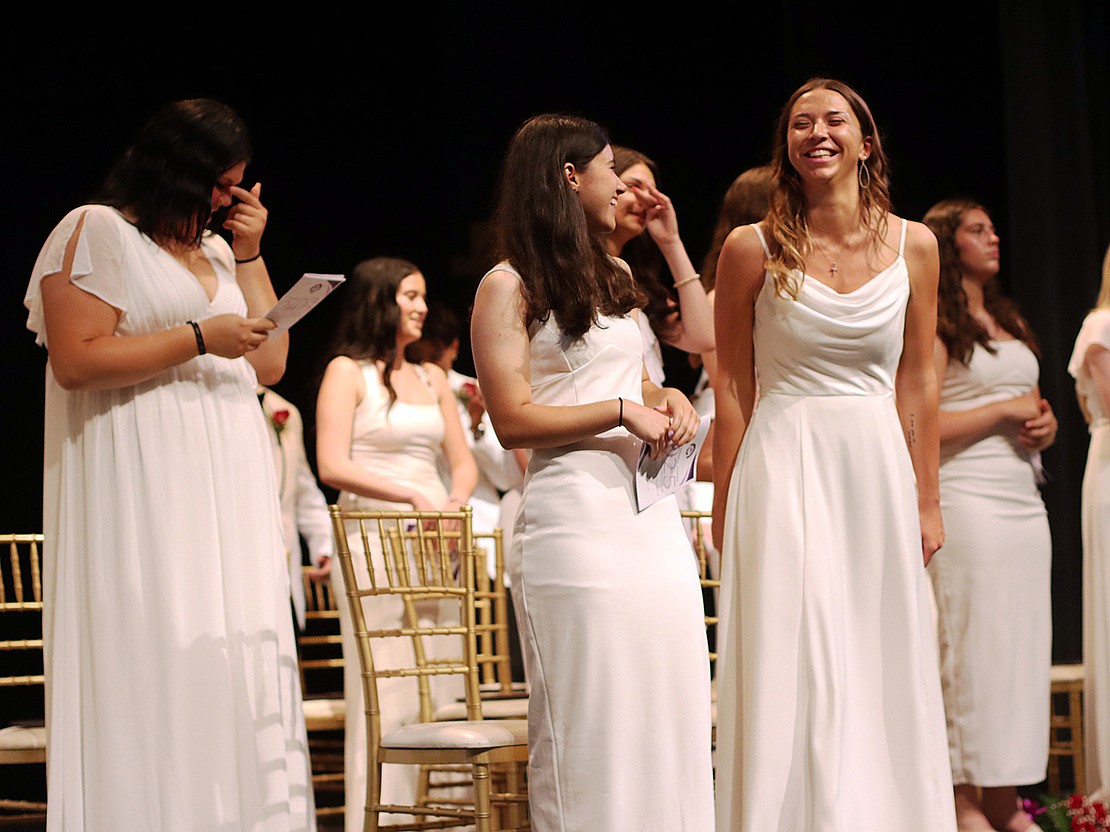 Valedictorian Macey Burns (r.) and salutatorian Isabella Lape celebrate with classmates following the singing of the alma mater during Catholic Central's 102nd Commencement on June 7 at Russell Sage College in Troy. (Tom Killips photo)