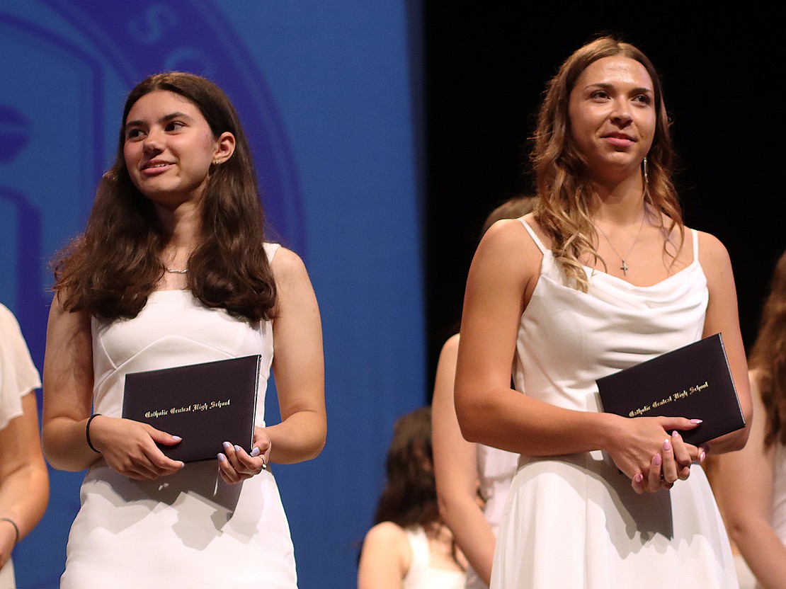 Salutatorian, Isabella Lape (.) and valedictorian Macey Burns hold their diplomas during Catholic Central's 102nd Commencement on June 7 at Russell Sage College in Troy. (Tom Killips photo)