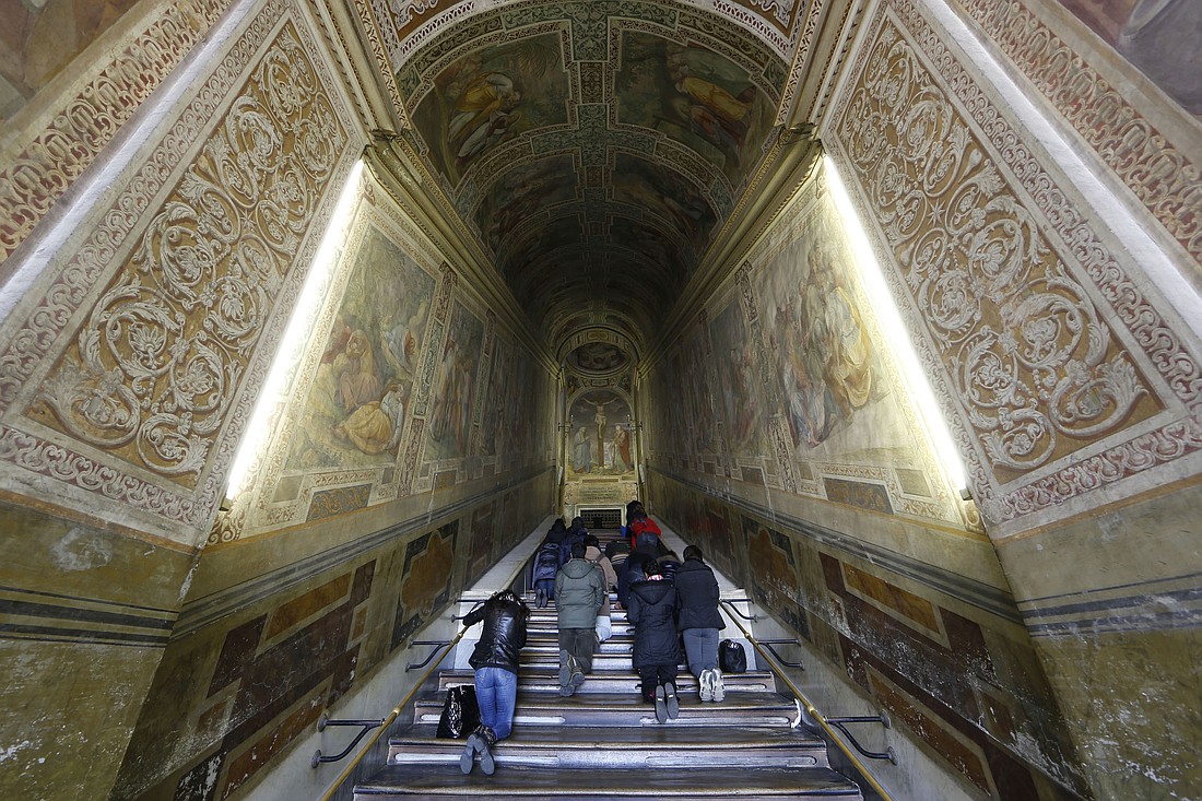 People walk on their knees as they pray at the Holy Stairs in Rome in this file photo. (CNS photo/Paul Haring)