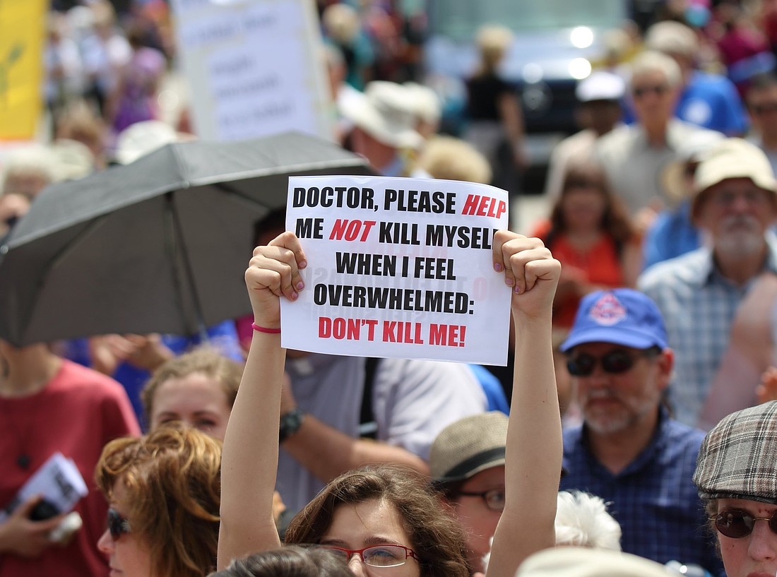 A woman is pictured in a file photo holding up a sign during a rally against assisted suicide on Parliament Hill in Ottawa, Ontario. A Canadian lawmaker says pushback has been growing against expanding assisted suicide to include those with mental illnesses in the weeks since she held a press conference July 9, 2025, in British Columbia on a bill she's introduced to block mental health as a sole criteria. (OSV News photo/Art Babych)