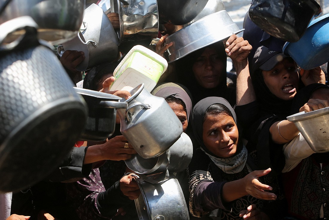 Displaced people wait to receive food Aug. 2, 2025, from a charity kitchen in Gaza City, Gaza Strip, amid a hunger crisis. In another development, Israeli Prime Minister Benjamin Netanyahu on Aug. 10 announced his plan to seize control of Gaza City and the remaining sliver of Gaza not already under Israeli control. A senior United Nations official warned the U.N. Security Council that Israel's plan risked "another calamity" in the Gaza Strip with far-reaching consequences. (OSV News photo/Hatem Khaled, Reuters)