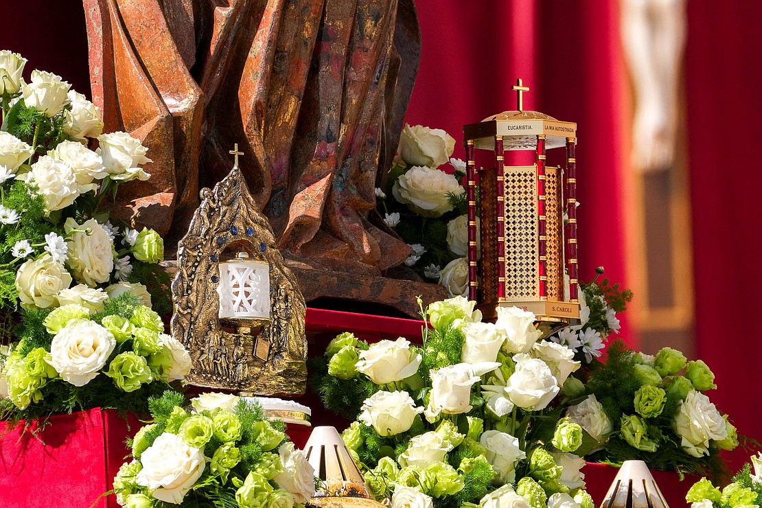 Reliquaries containing the relics of St. Carlo Acutis and St. Pier Giorgio Frassati stand at the foot of a statue of Mary during the canonization Mass celebrated by Pope Leo XIV in St. Peter’s Square at the Vatican Sept. 7, 2025. (CNS photo/Lola Gomez)