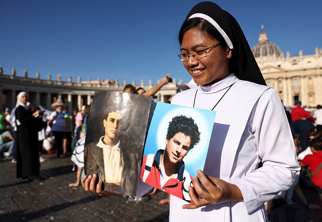A nun holds a picture of Carlo Acutis and Pier Giorgio Frassati on the day Pope Leo XIV leads the canonization Mass of Blessed Carlo Acutis, a British-born Italian boy who will become the first millennial to be made a Catholic saint, and Blessed Pier Giorgio Frassati, in St. Peter's Square at the Vatican, Sept. 7, 2025. (OSV News photo/Matteo Minnella, Reuters)