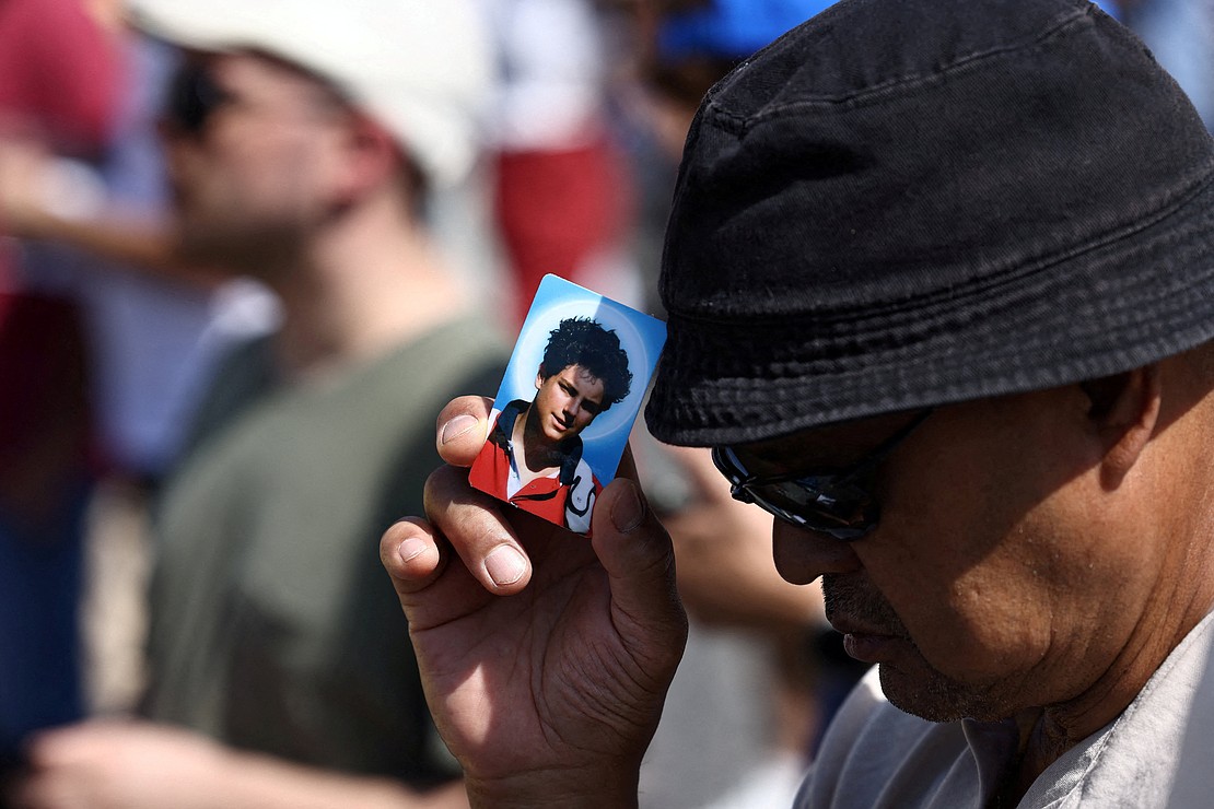 A faithful holds a picture of Carlo Acutis, as Pope Leo XIV leads a   Mass for the canonization of Carlo Acutis, a British-born Italian boy who will become the first millennial to be made a Catholic saint, and Pier Giorgio Frassati, in St. Peter's Square at the Vatican, Sept. 7, 2025. (OSV News photo/Matteo Minnella, Reuters)
