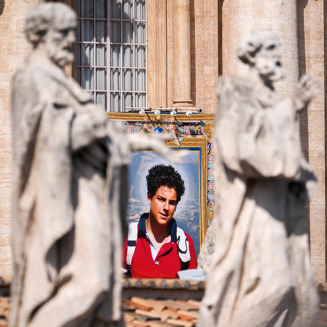 A tapestry depicting St. Carlo Acutis hangs from the facade of St. Peter’s Basilica during a canonization Mass at the Vatican Sept. 7, 2025. (CNS photo/Lola Gomez)