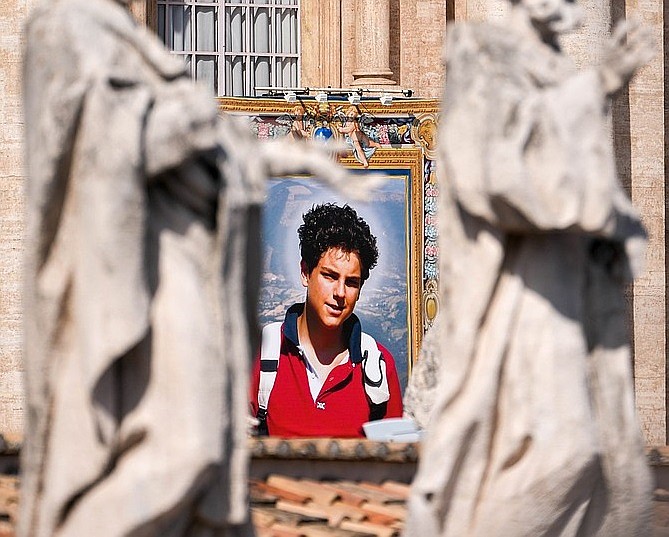 A tapestry depicting St. Carlo Acutis hangs from the facade of St. Peter’s Basilica during a canonization Mass at the Vatican Sept. 7, 2025. (CNS photo/Lola Gomez) (Courtesy photo of Lola Gomez)