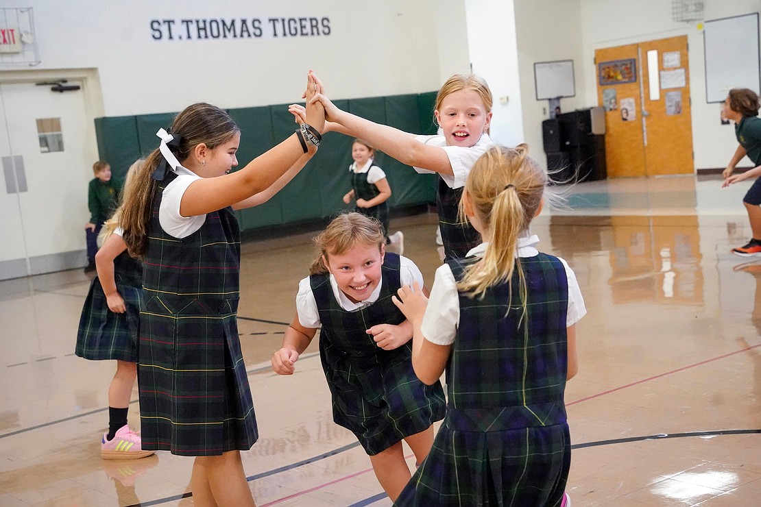 Ava Nagengast goes under the human bridge as she joins her fourth-grade class in a game of tag during gym on Sept. 11 at St. Thomas the Apostle School in Delmar. (Cindy Schultz photo for The Evangelist)