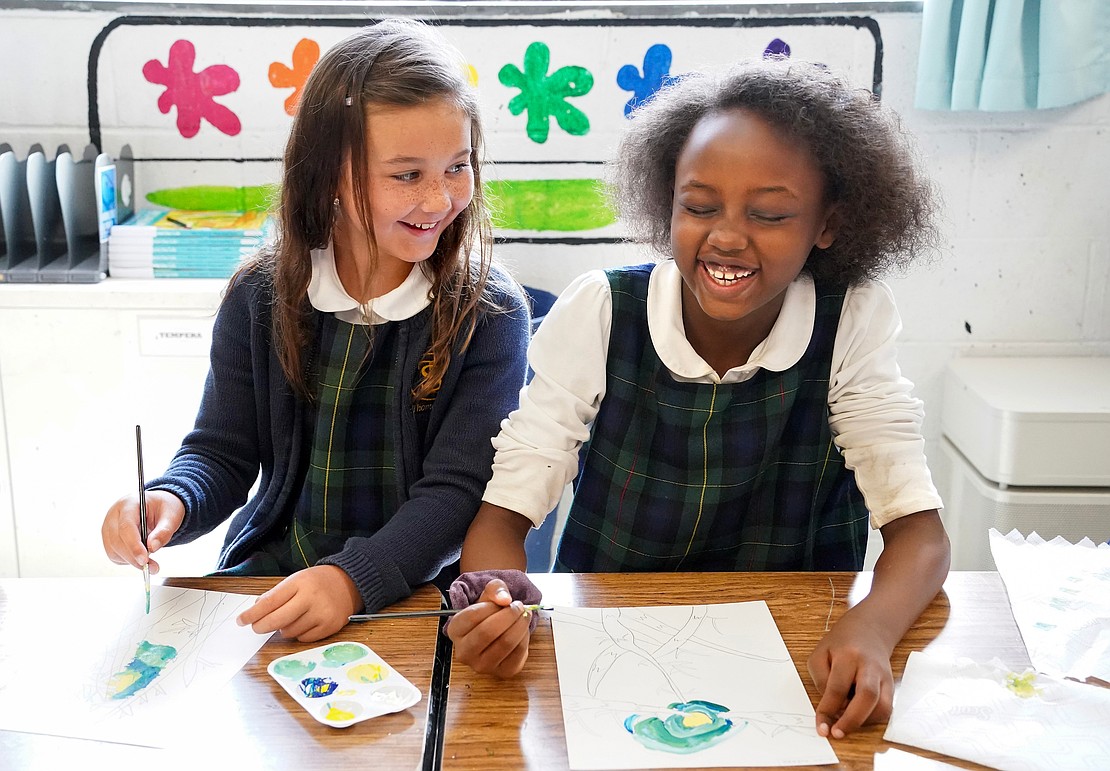 Third-graders Gia Vasto (l.) and Alian Huruma share a laugh during art class on Sept. 11 at St. Thomas the Apostle School in Delmar. (Cindy Schultz photo for The Evangelist)