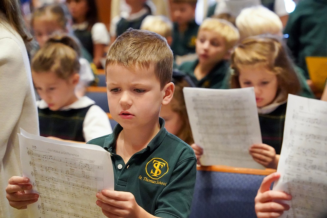 First-grader Tommy McAvoy studies the worksheet as students learn how to participate in Mass on Sept. 11 at St. Thomas the Apostle Church in Delmar. (Cindy Schultz photo for The Evangelist)