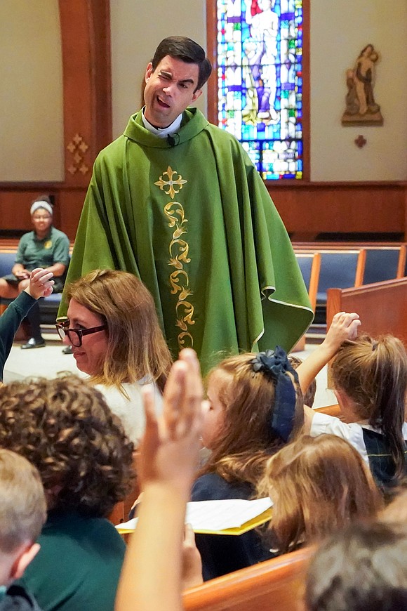 Father Matthew Duclos considers a student’s question as he teaches them how to participate in Mass on Sept. 11 at St. Thomas the Apostle Church in Delmar. (Cindy Schultz photo for The Evangelist)