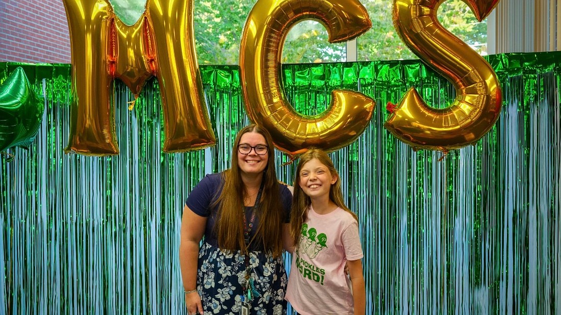 Ashley Romand, principal and fourth-grader Abby Schillinger are seen at Mater Christi’s Chalk the Walk night on Sept. 3. Romand, who took over as principal in July, taught kindergarten and preK at the school before taking on her new role. (Photo provided)